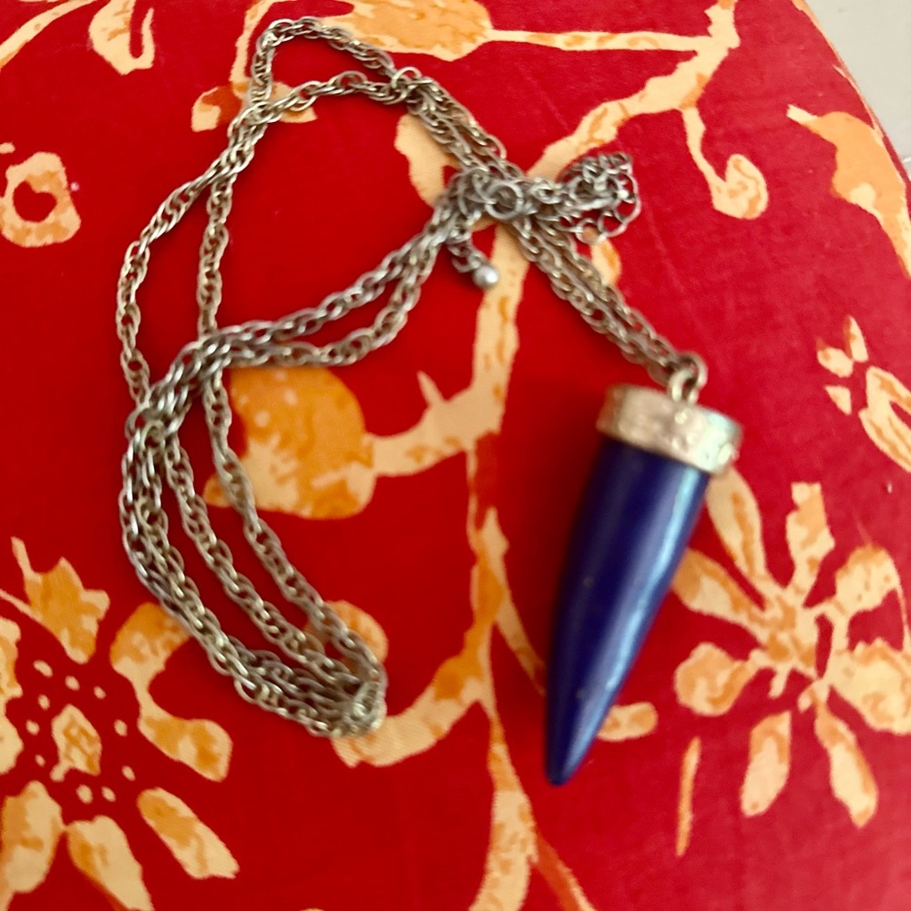 Lapiz tapered two inch pendant in gold tone setting in a long chain